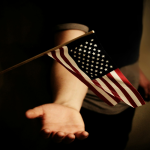 American flag being caught by hand
