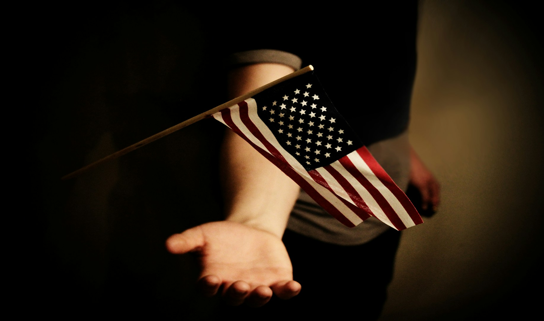 American flag being caught by hand